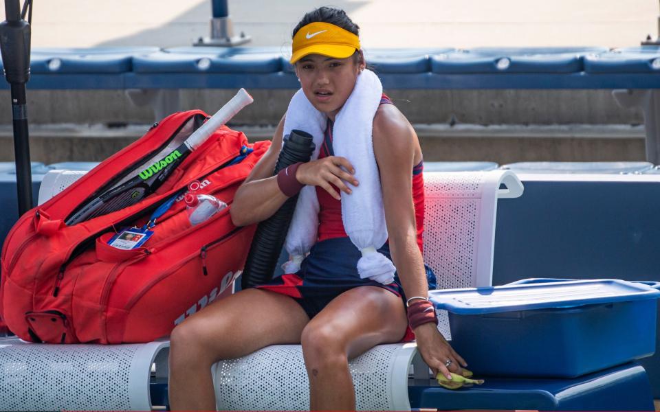 Emma Raducanu uses an ice towel and cold air blower to cool down between games - Getty