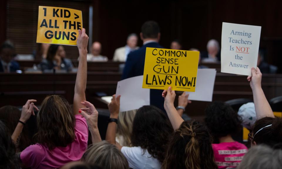 Supporters of gun safety reform hold signs during committee meetings at Cordell Hull State Office Building on Wednesday, Aug. 23, 2023, in Nashville, Tenn.