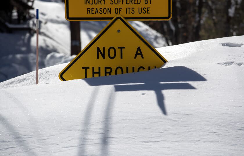 BIG BEAR LAKE, CA - MARCH 03: Many street signs are nearly covered as the Big Bear Valley digs out following successive storms which blanketed San Bernardino Mountain communities on Friday, March 3, 2023 in Big Bear Lake, CA. (Brian van der Brug / Los Angeles Times)