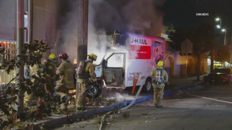 A U-Haul truck burst into flames after sideswiping a car and careening into a building in the Adams-Normandie neighborhood of South Los Angeles on May 8, 2024. (KNN)