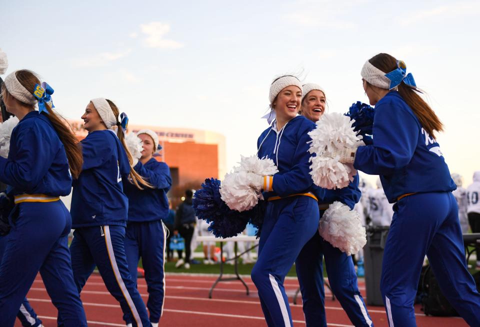 O'Gorman cheerleaders laugh together on the sidelines in the football quarterfinals on Thursday, October 28, 2021, at Howard Wood Field in Sioux Falls.