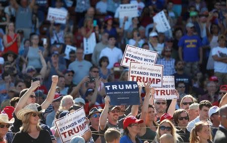 Supporters hold signs as Republican U.S. presidential candidate Donald Trump speaks during a campaign rally in Lynden, Washington, U.S., May 7, 2016. REUTERS/Jim Urquhart