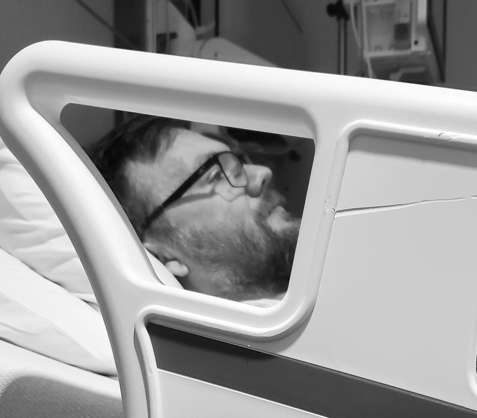 Wilson lies in a hospital bed.