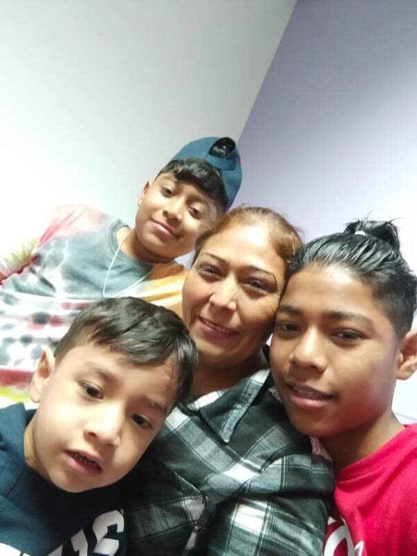 Doris poses for a photo alongside her sons Francisco, Carlos and Diego. The family from Honduras is now living in a shelter in New York City. / Credit: CBS News