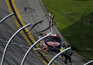 Christopher Bell celebrates at the finish line after winning the NASCAR Cup Series road course auto race at Daytona International Speedway, Sunday, Feb. 21, 2021, in Daytona Beach, Fla. (AP Photo/Terry Renna)