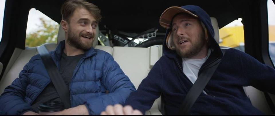 Daniel Radcliffe and David Holmes in the backseat of a car.