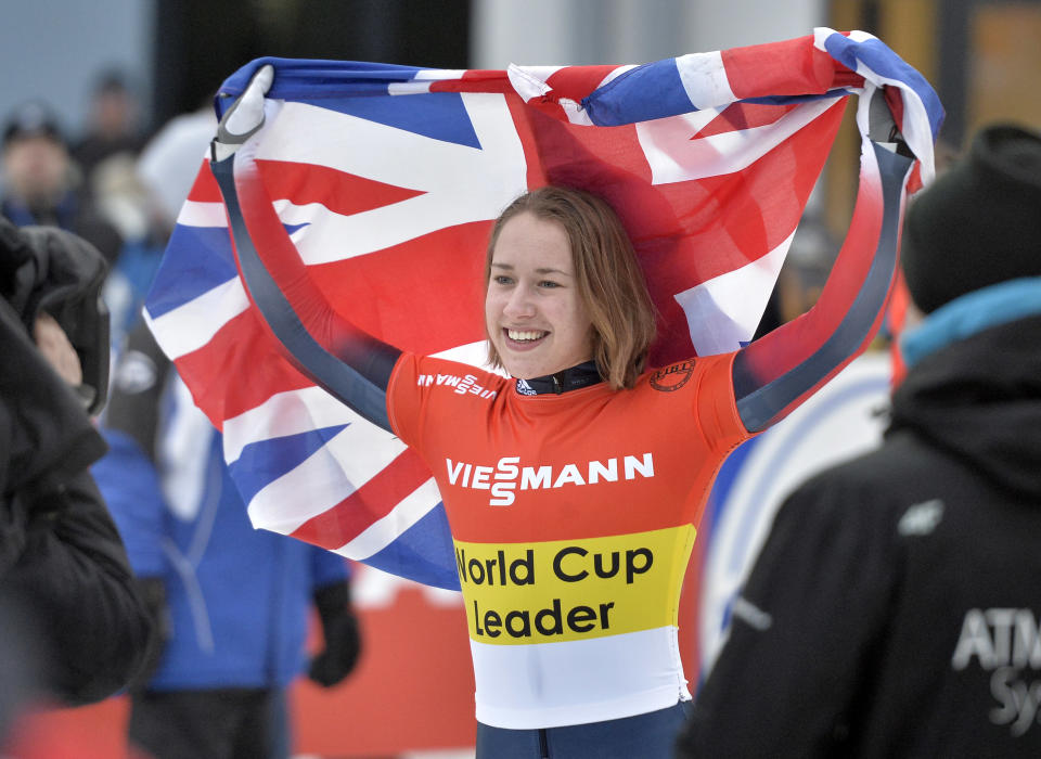 Elizabeth Yarnold of Great Britain celebrates with the flag after winning the women's Skeleton World Cup in Winterberg, Germany, on Saturday, Jan. 4, 2014. (AP Photo/Martin Meissner)