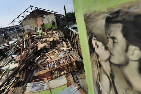 People demolish a cafe building at Kalijodo red-light district in Jakarta, Indonesia, February 23, 2016 in this picture taken by Antara Foto. REUTERS/Wahyu Putro A/Antara Foto