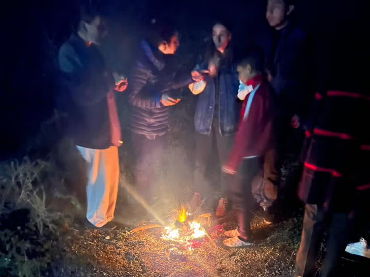 Families gather around a fire to make food in the journey out of Nagorno-Karabakh (Handout)