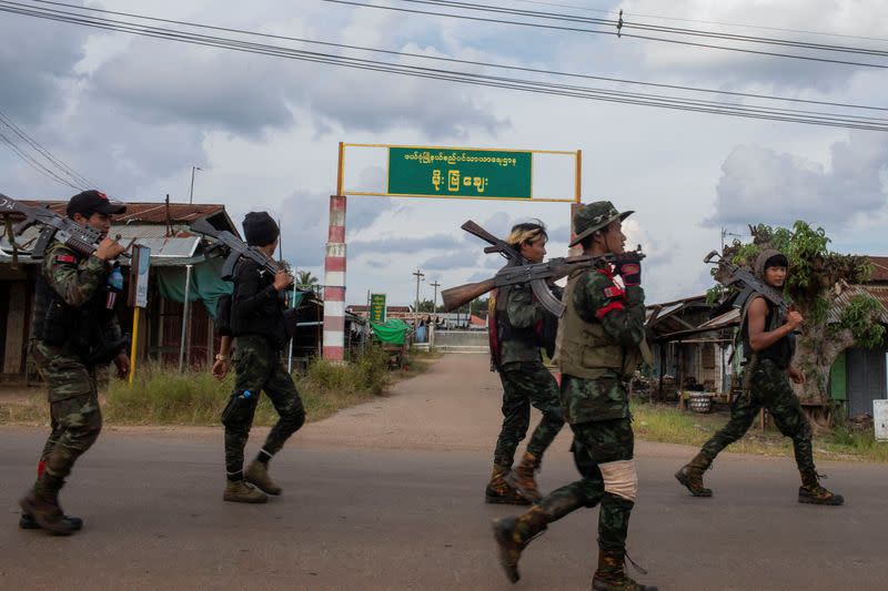 Volunteer members of Karenni insurgent forces walk in Moe Bye in Kayah State