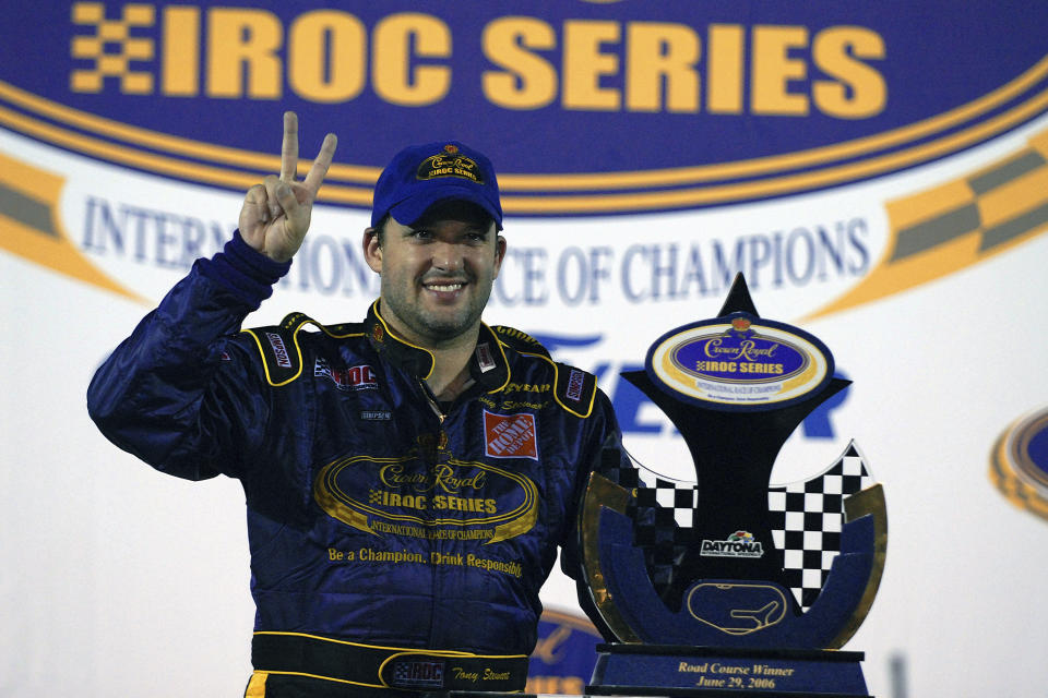 FILE - In this June 26, 2006, file photo, Tony Stewart poses with the trophy after winning the Crown Royal IROC auto race in Daytona Beach, Fla. The IROC Series, where the best drivers from various disciplines raced each other in equally prepared cars, ran for 30 seasons before Tony Stewart won its final championship in 2006 and the series quietly went away. Now Stewart, along with fellow NASCAR Hall of Famer Ray Evernham, has teamed with a group of heavyweights to bring an all-star circuit back in 2021. The Superstar Racing Experience plans a six-race, short-track series to air in prime-time on CBS in a Saturday night summer spectacular. (AP Photo/Paul Kizzle, File)