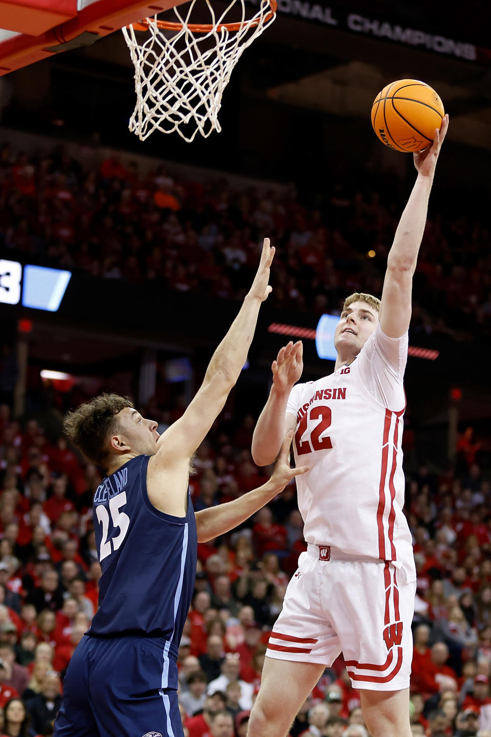 MADISON, WISCONSIN – MARCH 19: Steven Crowl #22 of the Wisconsin Badgers scores over Zach Cleveland #25 of the Liberty Flames during the first half in the second round of the NIT Men’s Basketball Tournament at Kohl Center on March 19, 2023 in Madison, Wisconsin. (Photo by John Fisher/Getty Images)