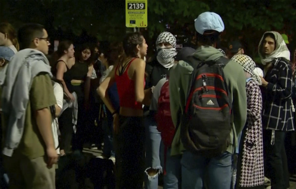 In this image taken from video, protestors against the Israel-Hamas war stand outside near the campus of George Washington University in Washington, Wednesday, May 8, 2024. Tensions have continued to ratchet up in standoffs with protesters on campuses across the U.S. and increasingly, in Europe, nearly three weeks into a movement launched by a protest at Columbia University. (WJLA via AP)