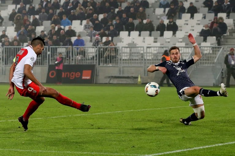 Monaco's Colombian forward Radamel Falcao (L) shoots to score a goal against Bordeaux at the Matmut Atlantique Stadium in Bordeaux, southwestern France, on December 10, 2016