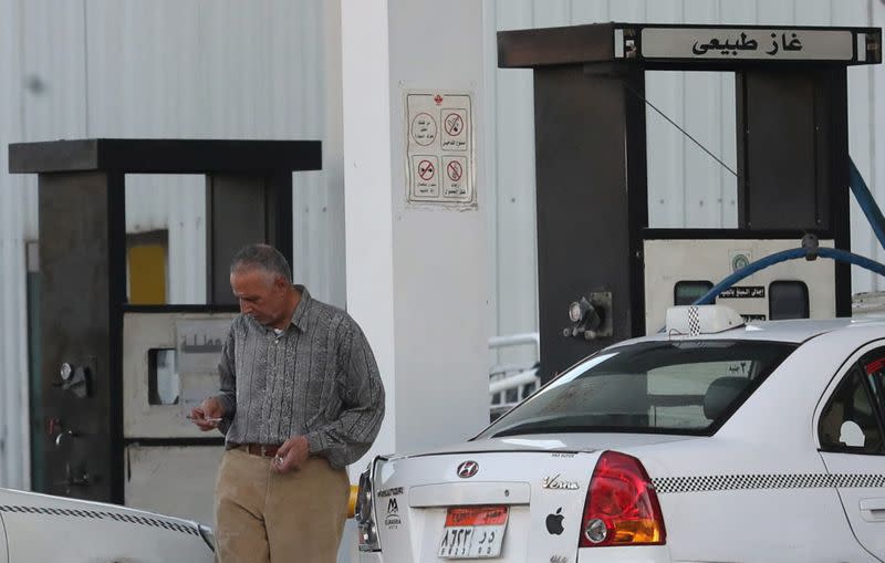 A taxi driver walks after he filled up with gas at Natural Gas Vehicles (NGV) petrol station in Cairo