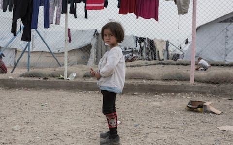 A girl stands in the section for foreign families at a camp for people who lived under Isiland are now displaced, in al-Hol, near Hasakeh in Syria - Credit: Sam Tarling