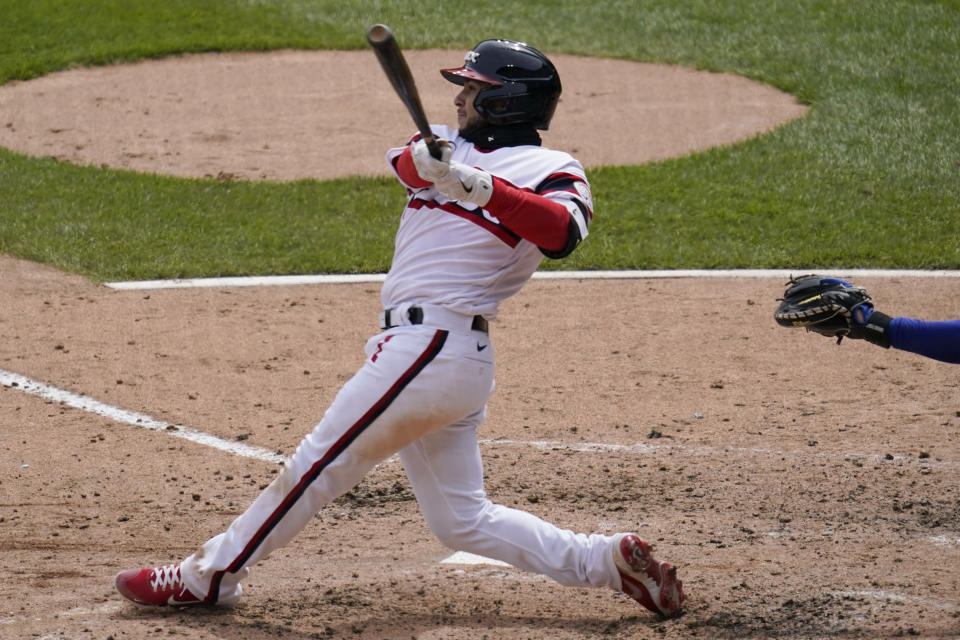 Chicago White Sox's Nick Madrigal hits a two-run triple during the third inning of a baseball game against the Texas Rangers in Chicago, Sunday, April 25, 2021. (AP Photo/Nam Y. Huh)