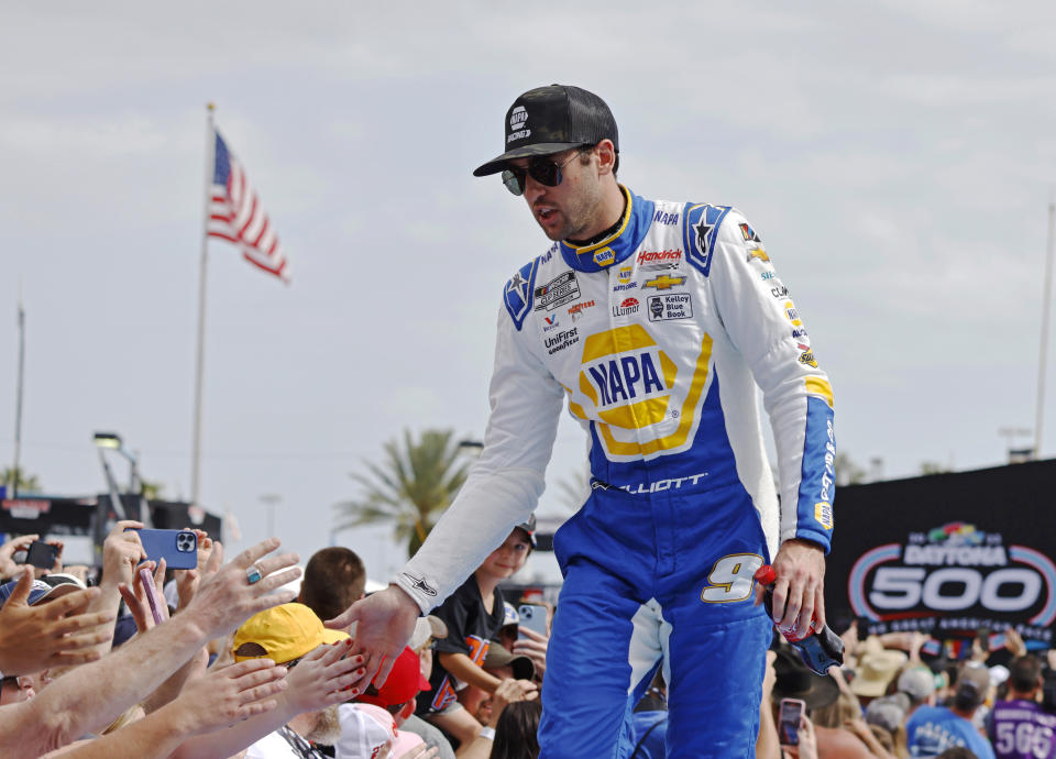FILE - Chase Elliott greets fans during driver introductions before the NASCAR Daytona 500 auto race at Daytona International Speedway on Feb. 19, 2023, in Daytona Beach, Fla. Elliott has injured his leg in a snowboarding accident in Colorado and will miss this weekend’s NASCAR race at Las Vegas. Hendrick Motorsports said NASCAR’s most popular driver was scheduled to have surgery Friday evening. Elliott was injured Friday, March 3. (AP Photo/Terry Renna, File)