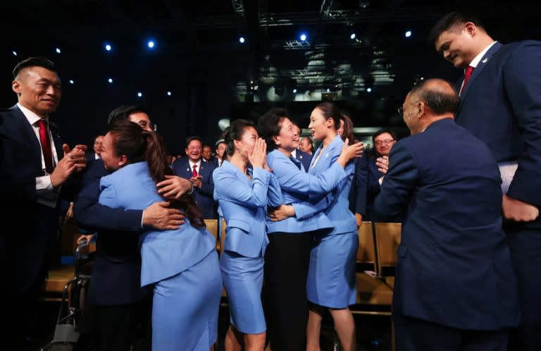 Members of the Beijing delegation celebrate in Kuala Lumpur on July 31, 2015 after Beijing was named as the host city for the 2022 Winter Olympic Games