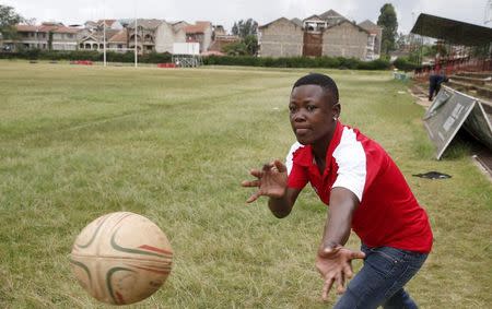 Kenya Women's Rugby team player Irene Otieno passes the ball during a light training session at the RFUEA grounds in the capital Nairobi, April 4, 2016. REUTERS/Thomas Mukoya