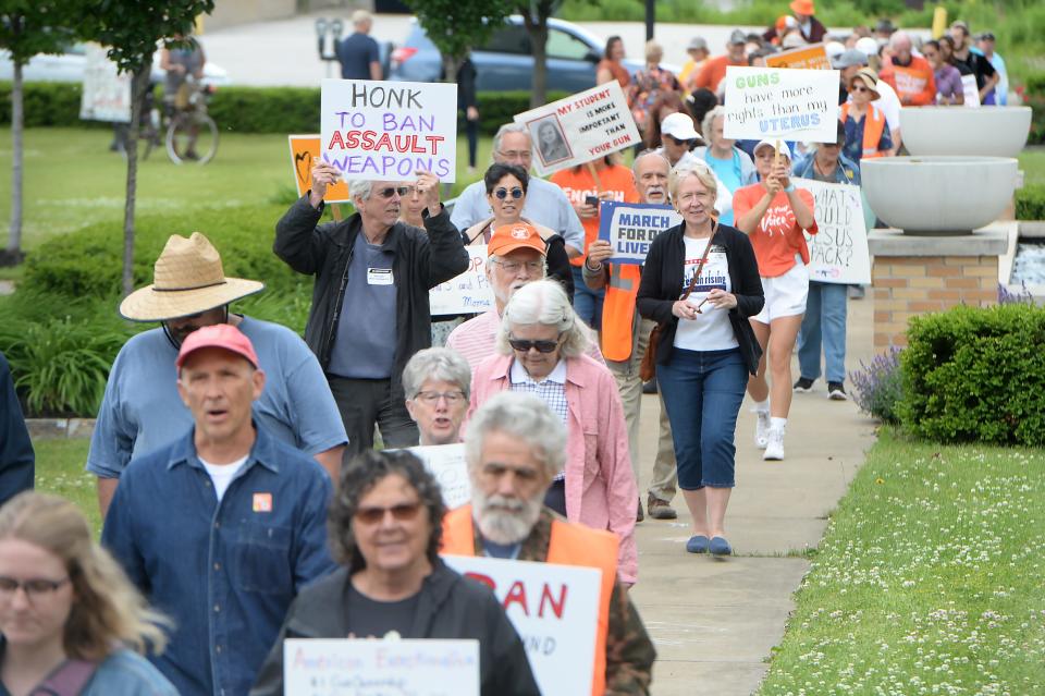 About 100 people gather for a "March For Our Lives" anti-gun-violence rally at Griswold Park in Erie on June 11, 2022. 