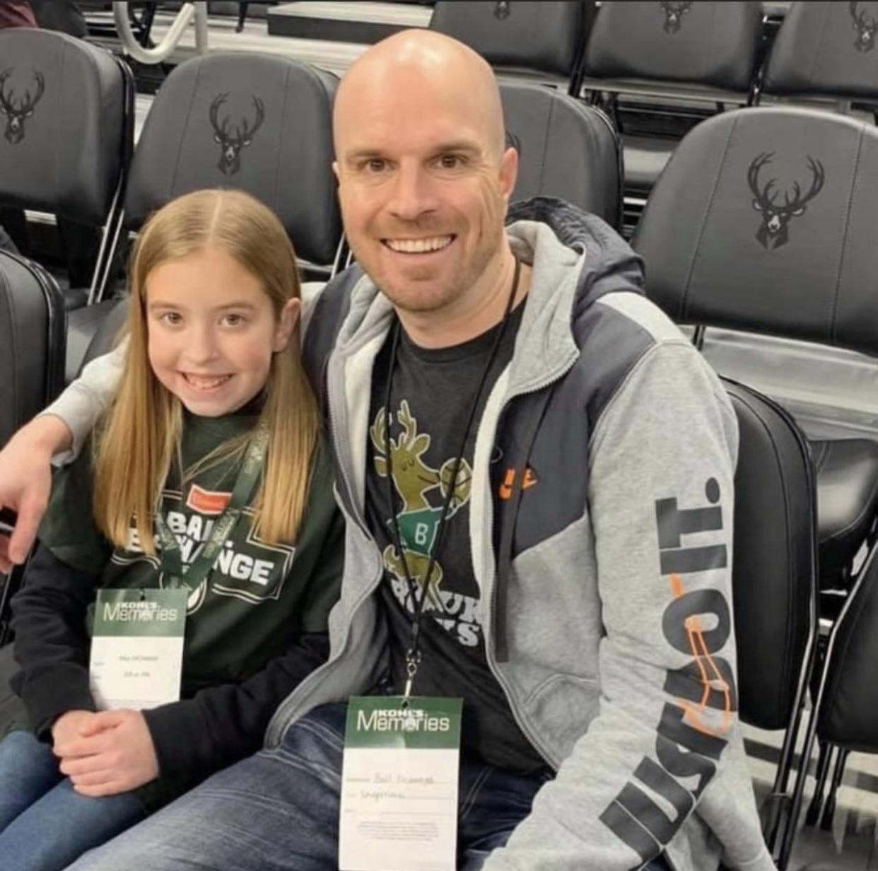 Justin Wills poses with his daughter, Jada, when the two attended Milwaukee Bucks postseason games in the summer of 2021. Wills mashed together Milwaukee's run of success with Encanto's "We Don't Talk About Bruno."