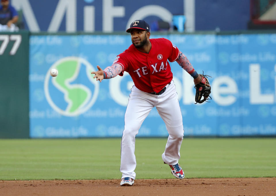 Texas Rangers shortstop Elvis Andrus tosses the ball to second for the force out on Los Angeles Angels' Shohei Ohtani during the first inning of a baseball game in Arlington, Texas, Thursday, July 4, 2019. (AP Photo/Tony Gutierrez)