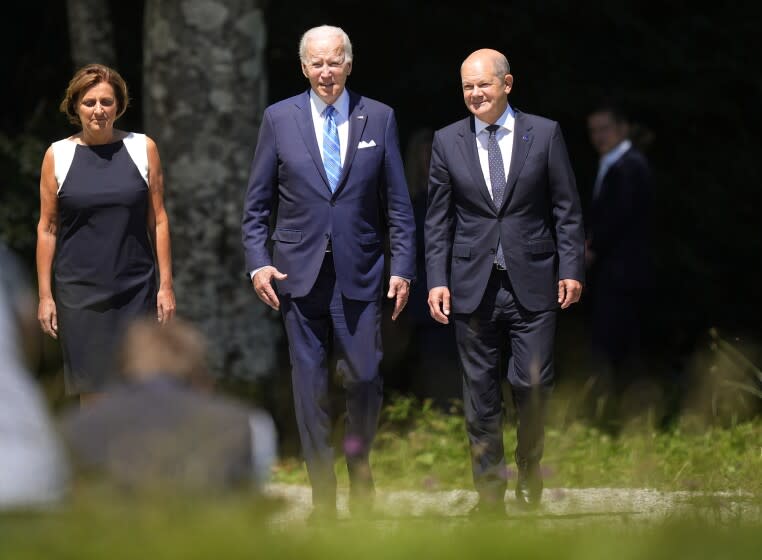 German Chancellor Olaf Scholz, right, and U.S. President Joe Biden, center, arrive for the official G7 summit welcome ceremony at Castle Elmau in Kruen, near Garmisch-Partenkirchen, Germany, on Sunday, June 26, 2022. The Group of Seven leading economic powers are meeting in Germany for their annual gathering Sunday through Tuesday. (AP Photo/Martin Meissner)