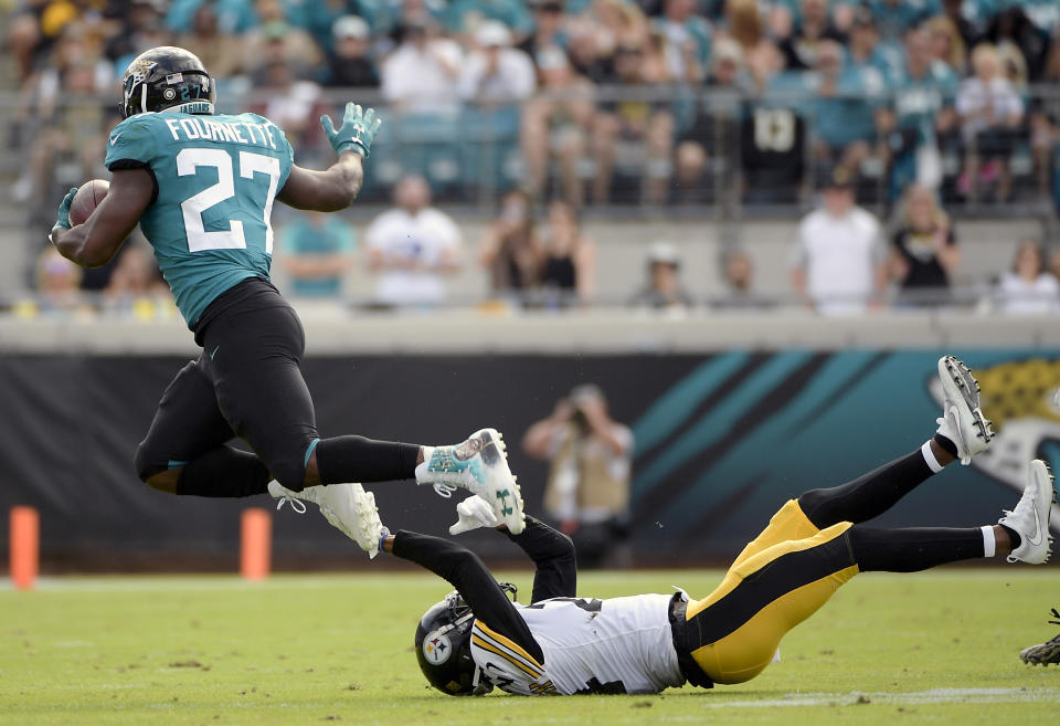 Jacksonville Jaguars running back Leonard Fournette (27) runs over Pittsburgh Steelers cornerback Coty Sensabaugh for yardage during the first half of an NFL football game, Sunday, Nov. 18, 2018, in Jacksonville, Fla. (AP Photo/Phelan M. Ebenhack)