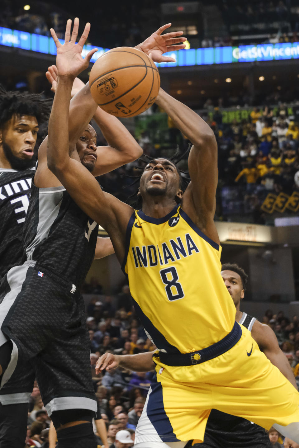 Indiana Pacers forward Justin Holiday (8) loses the ball in front of Sacramento Kings guard Yogi Ferrell (3) during the second half of an NBA basketball game in Indianapolis, Friday, Dec. 20, 2019. The Pacers won 119-105. (AP Photo/AJ Mast)