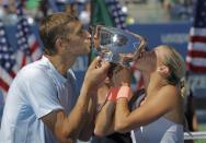 Andrea Hlavackova of the Czech Republic and Max Mirnyi of Belarus kiss their trophy after defeating Abigail Spears of the U.S. and Santiago Gonzalez of Mexico in the mixed doubles final at the U.S. Open tennis championships in New York September 6, 2013. REUTERS/Eduardo Munoz