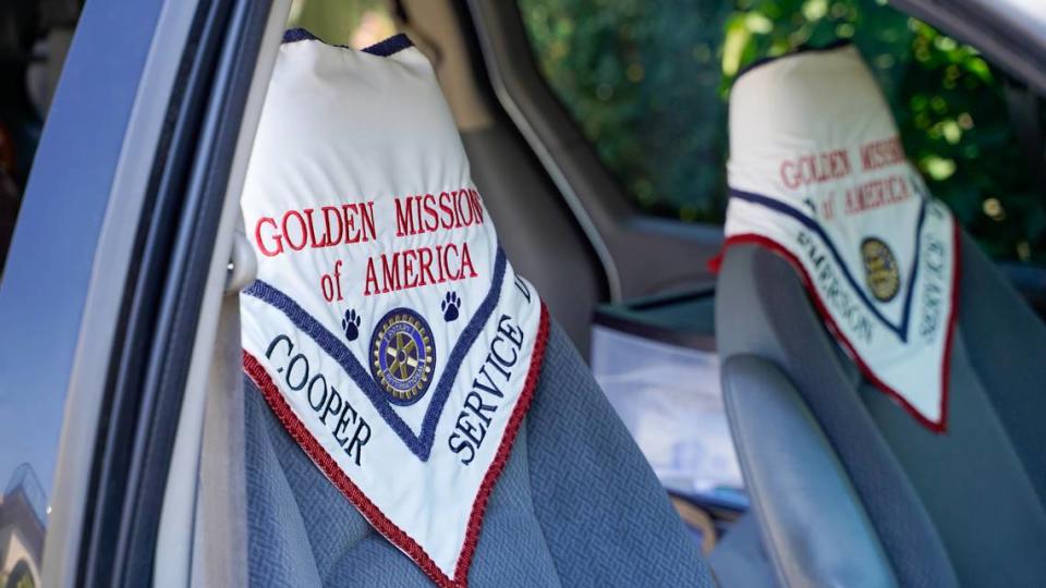 The bandanas worn by dogs with Golden Missions of America hang from seats in Golden Missions founder Dan Sievert’s van. Sievert and his golden retrievers have made 55 missions across the United States over the past decade, helping victims of tragedies work through their trauma. John Lynch/jlynch@thetribunenews.com