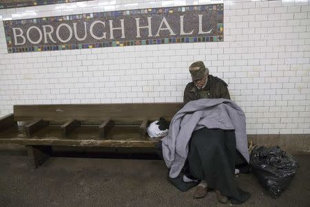 A man sleeps on a seat at the Borough Hall subway station in the Brooklyn borough of New York in this February 10, 2015, file photo. REUTERS/Shannon Stapleton/Files