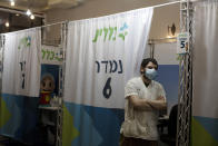 FILE - In this Aug. 15, 2021, file photo, a medical professional waits for his next patient to administer a booster shot for the coronavirus vaccine, at Clalit Health Services, one of Israel's health maintenance organizations, in Jerusalem. Israel is pressing ahead with its aggressive campaign of offering coronavirus boosters to almost anyone over 12 and says its approach was further vindicated by a U.S. decision to give the shots to older patients or those at higher risk. (AP Photo/Maya Alleruzzo, File)