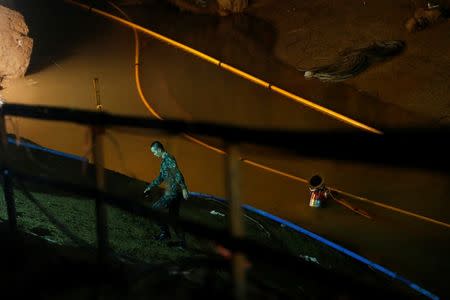 A soldier walks in Tham Luang cave complex, as an ongoing search for members of an under-16 soccer team and their coach continues, in the northern province of Chiang Rai, Thailand, July 1, 2018. REUTERS/Soe Zeya Tun