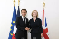 FILE - British Prime Minister Liz Truss and French President Emmanuel Macron, left, shake hands as they hold a bilateral meeting ahead of the 77th United Nations General Assembly in New York, Tuesday Sept. 20, 2022. After an acrimonious divorce and years of bickering, Britain’s government looks like it wants to make up with the European Union. On Thursday, Oct. 6 Truss travels to the Czech Republic to attend the first meeting of the European Political Community, an initiative of French President Emmanuel Macron that brings together EU members and countries outside the union. (Stefan Rousseau/Pool Photo via AP, file)