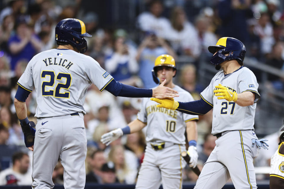 Milwaukee Brewers' Willy Adames, right, is congratulated by Christian Yelich after hitting a two-run home run the scored Yelich against the San Diego Padres in the fifth inning of a baseball game Thursday, June 20, 2024, in San Diego. (AP Photo/Derrick Tuskan)