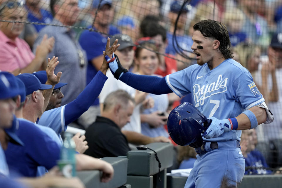 Kansas City Royals shortstop Bobby Witt Jr. celebrates as he enters the dugout after hitting a three-run home run during the second inning of a baseball game against the St. Louis Cardinals Friday, Aug. 11, 2023, in Kansas City, Mo. (AP Photo/Charlie Riedel)