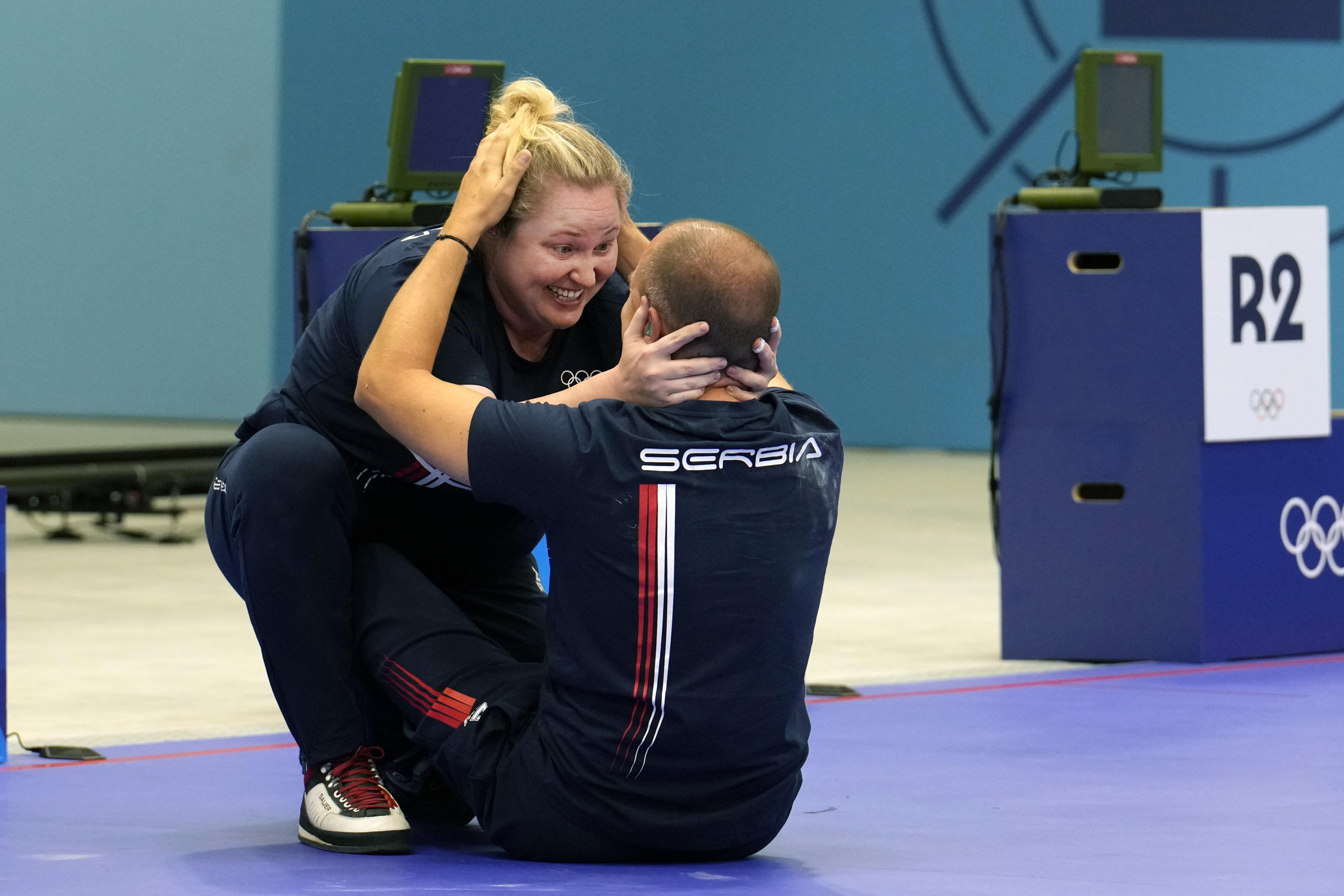 Serbia's Zorana Arunovic, left, and Damir Mikec celebrate after winning the gold medal in the 10m air pistol mixed team event at the 2024 Summer Olympics on July 30, 2024, in Chateauroux, France. (Manish Swarup/AP)