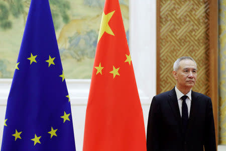 Chinese Vice Premier Liu He stands next to Chinese and European Union flags before the EU-China High-level Economic Dialogue with European Commission Vice President Jyrki Katainen at Diaoyutai State Guesthouse in Beijing, China, June 25, 2018. REUTERS/Jason Lee