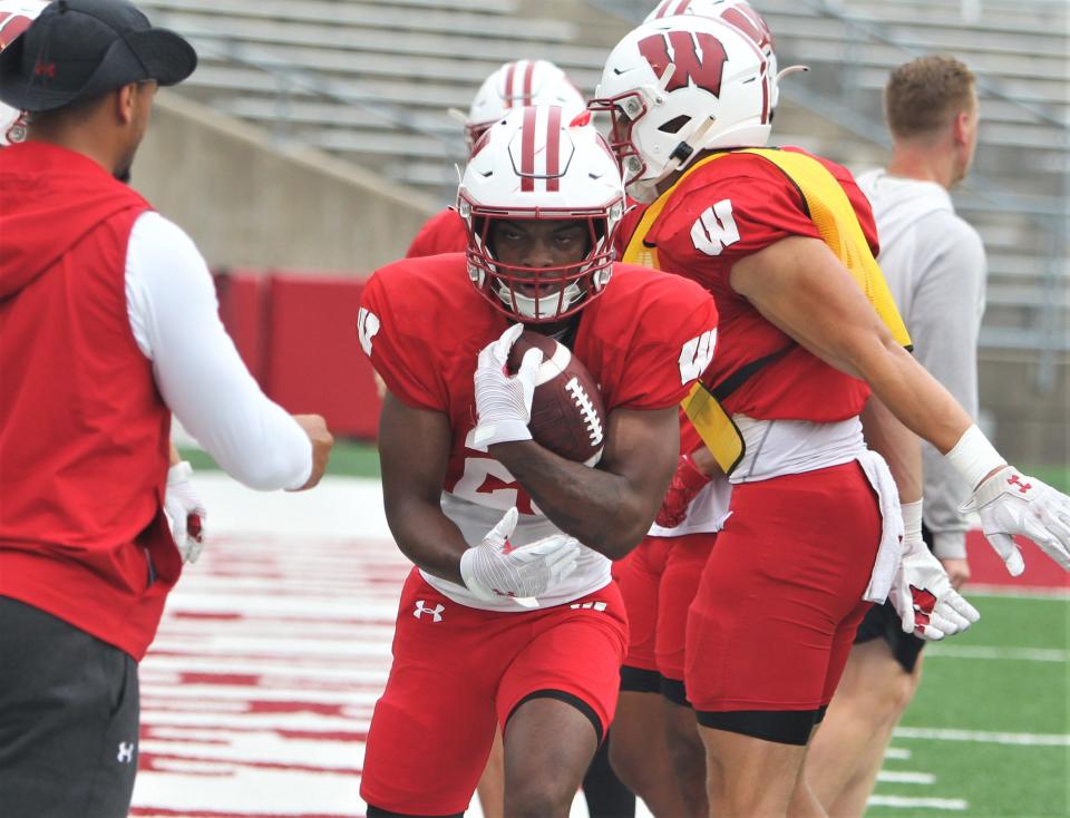 Wisconsin running back Nate White protects the ball as he goes through a drill during practice on Wednesday Aug. 9, 2023 at Camp Randall Stadium in Madison, Wis.