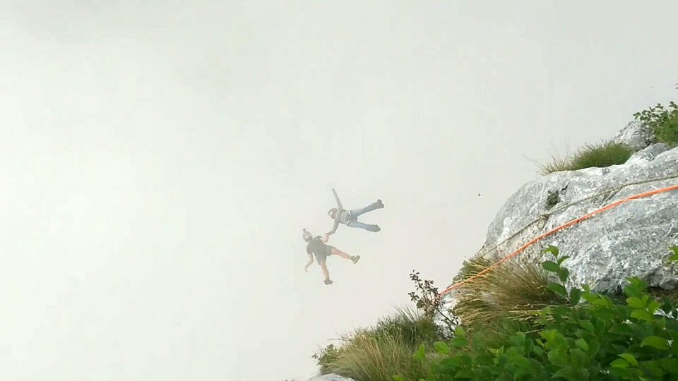 These friends filmed themselves freefalling backwards from a cliff - while holding hands. Josephine Eve, 28, and Niclas Strohmeier, 23, performed the stunt at the BASE jumping hotspot of Monte Brento, Italy. They fall backwards into the dense mist below before separating in the air and landing safely.