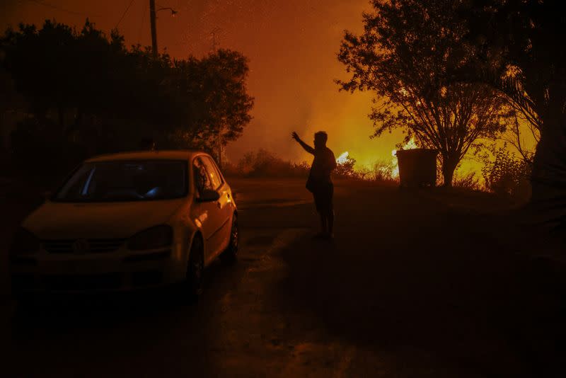 Wildifre burns in the village of Latas in southern Greece