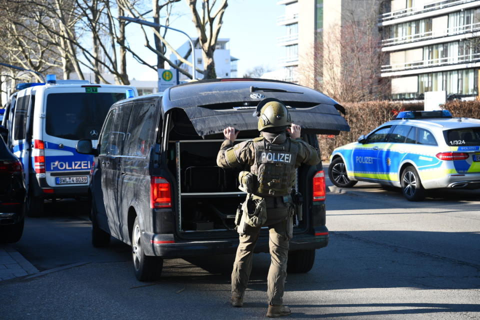 A member of the SEK stands by a vehicle on the campus of Heidelberg University in Heidelberg, Germany, Monday, Jan. 24, 2022. German police say a lone gunman wounded several people at a lecture theatre in the southwest city of Heidelberg on Monday. Police said in a brief statement that the perpetrator was dead but didn’t give details of how that happened. (R.Priebe/Pr-Video/dpa via AP)