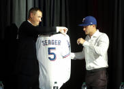 Texas Rangers General Manager Chris Young presents newly signed infielder Corey Seager with a jersey at a press conference at Globe Life Field Wednesday, Dec. 1, 2021, in Arlington, Texas. The Texas Rangers have finalized the contracts for their new half-billion dollar middle infield, wrapping up their deals Wednesday, Dec. 1, 2021 with two-time All-Star shortstop Corey Seager and Gold Glove second baseman Marcus Semien.(AP Photo/Richard W. Rodriguez)