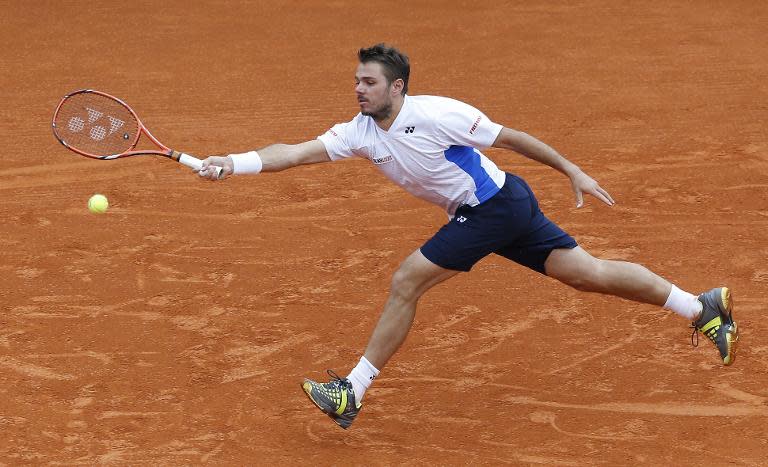 Switzerland's Stanislas Wawrinka hits a return to compatriot Roger Federer during their Monte Carlo ATP Masters Series Tournament final, in Monaco, on April 20, 2014