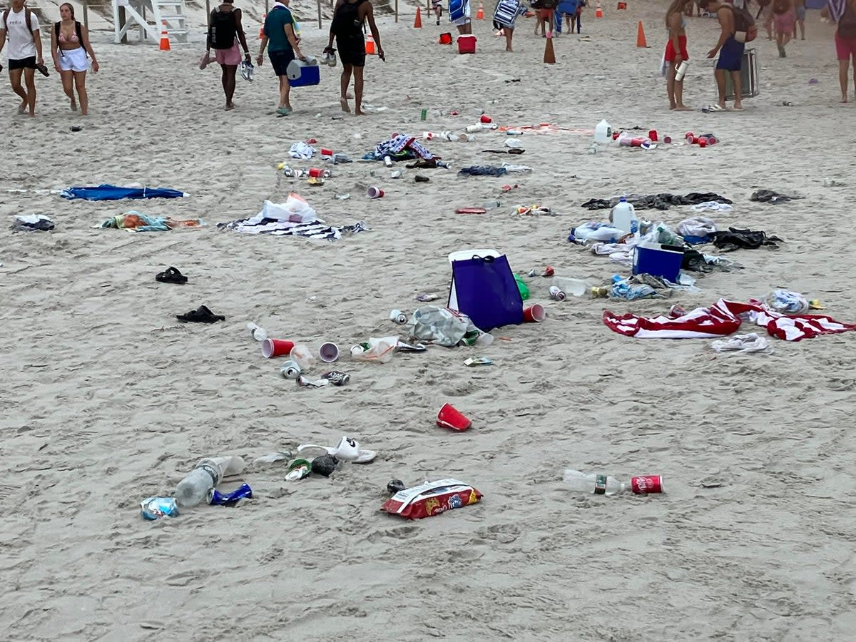 Trash left behind on July 4, 2023 on a beach in Dennis, Massachusetts. There will be no daily parking passes sold at Mayflower, Chapin, and Bayview beaches on the holiday this year, police say (Dennis Police Dept)