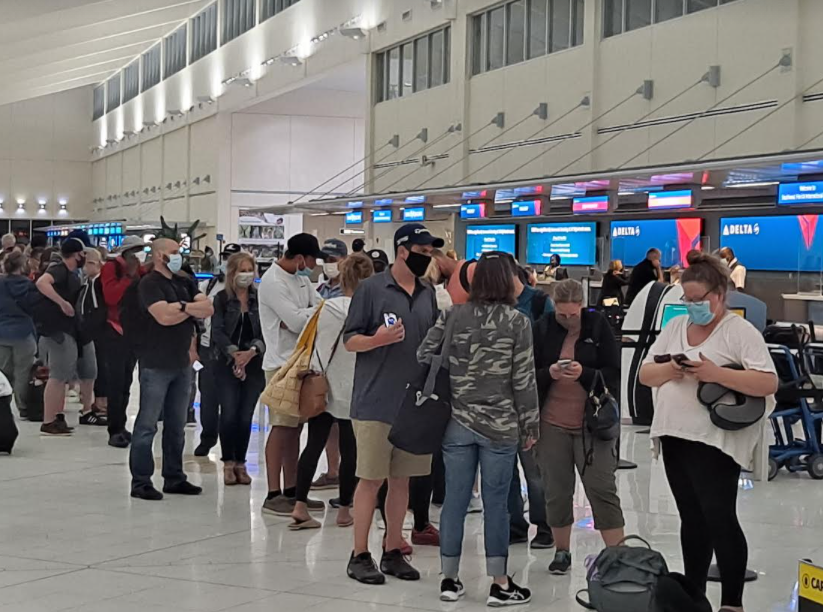 Dozens of would-be passengers on Spirit Airlines stand in a line seeking information on when they could fly out of Fort Myers.  Flight delays and cancelations attributed to weather conditions forced cancellation of dozens of planes.