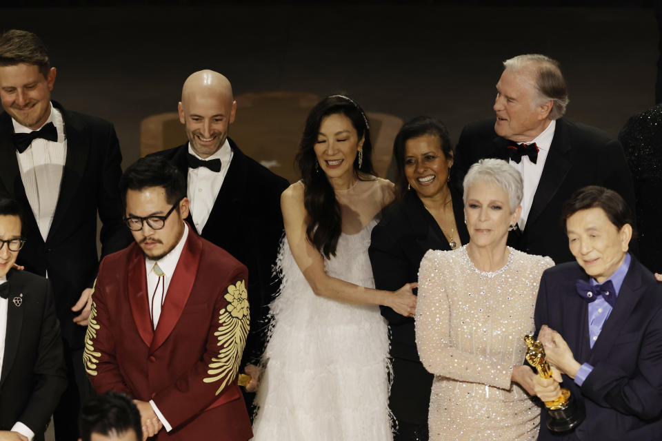 HOLLYWOOD, CALIFORNIA - MARCH 12: Daniel Kwan, Michelle Yeoh, Jamie Lee Curtis, James Hong, and cast and crew accept the Best Picture award for 