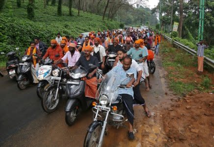 Hindu devotees take part in a motorcycle rally as part of a protest against the lifting of ban by Supreme Court that allowed entry of women of menstruating age to the Sabarimala temple, at Nilakkal Base camp in Pathanamthitta district in the southern state of Kerala, India, October 16, 2018. REUTERS/Sivaram V